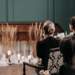 people sitting in front of a wooden casket.